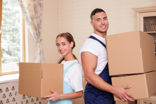 Local movers handling furniture in a Kingston residential street