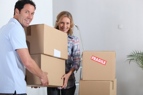 Professional movers packing household items in a Kingston property